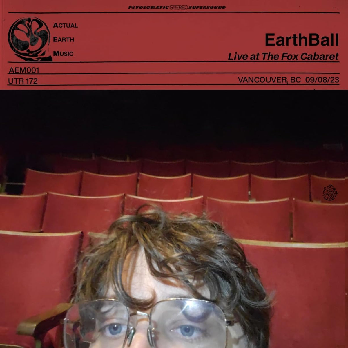 Vinyl record cover with a portrait of a man with glasses and long hair.