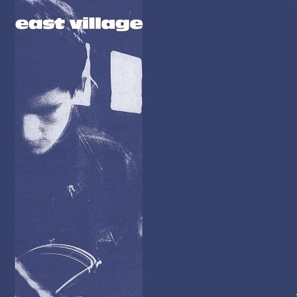 Dark blue vinyl record cover with a blurred portrait and cymbal.