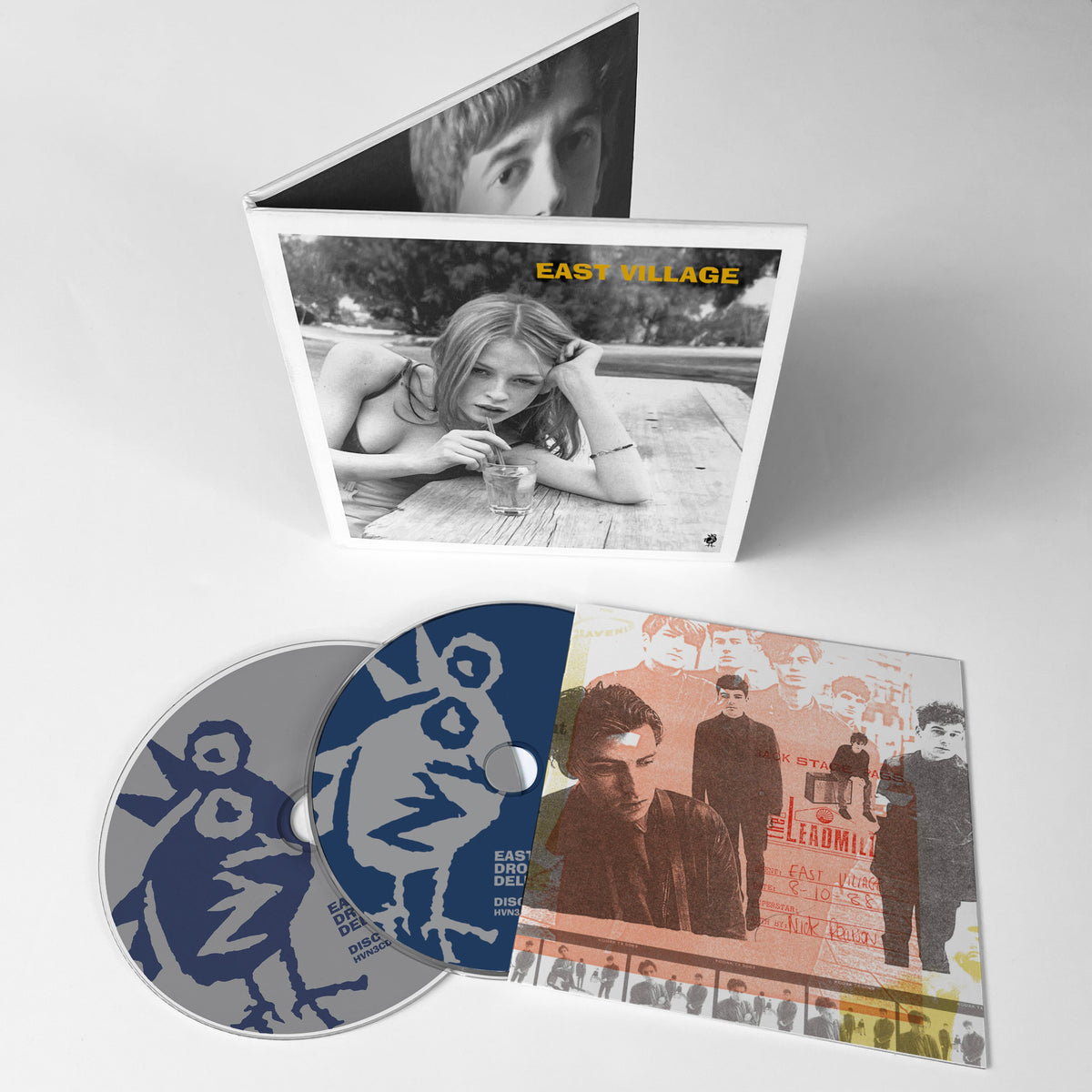 CD case open, showing disc, booklet with black and white photos.