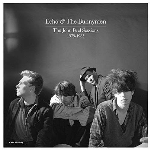 Black and white vinyl album cover featuring four band members in various poses.