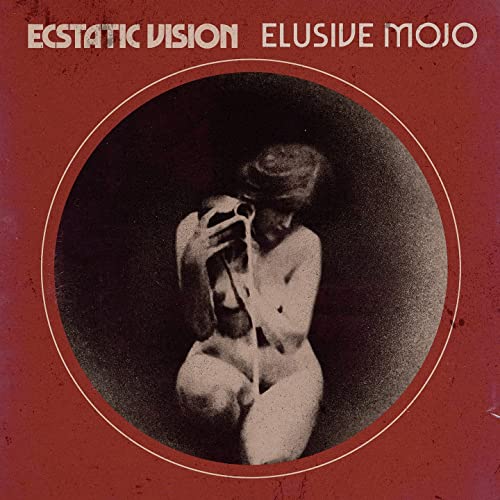 Red album cover featuring a grayscale image of a person with a camera.