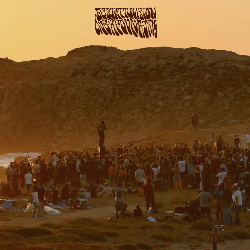 Album cover with a crowd gathered on a hillside at sunset.