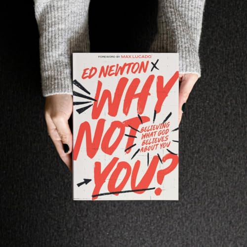 Book cover with red text reading "Why Not You?" held in hands.