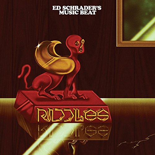 Vinyl album cover featuring a red creature on a pedestal with "Riddles" text.