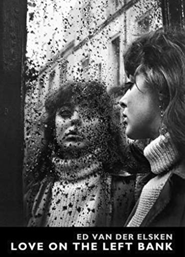 Black and white photo of two women seen through a rain-streaked window.