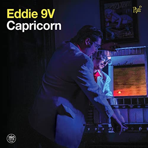 Album cover for Eddie 9V's "Capricorn" featuring two people at a Wurlitzer.