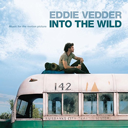 CD cover: man on a bus roof under a blue sky.