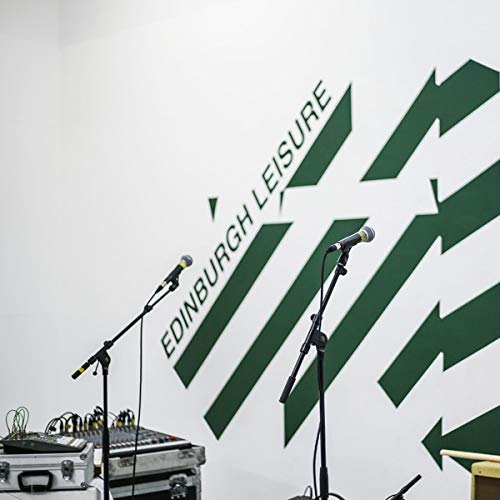 Vinyl record cover with green arrows and microphone stands.
