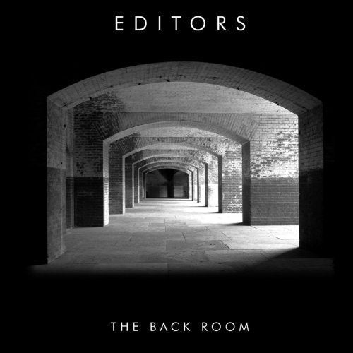 Black and white photo of brick arches leading down a corridor, with text overlay.