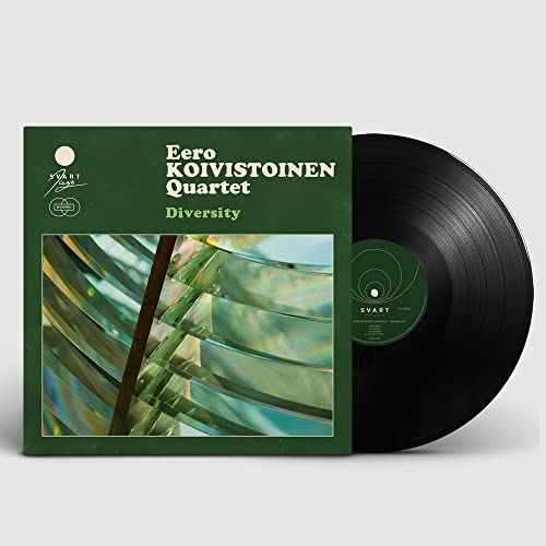 Vinyl record with green album cover featuring abstract colorful shapes.
