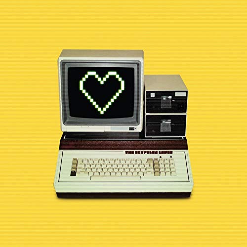 Vintage Apple IIe computer with pixelated heart on screen against a yellow background.