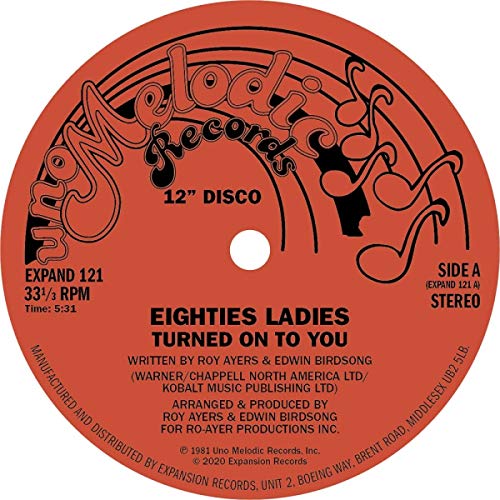 Red vinyl record label with black text and musical notes.