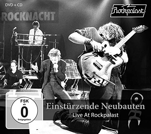 Black and white concert photo of Einstürzende Neubauten performing live.