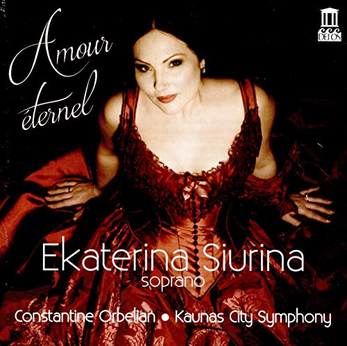 Woman in red dress sitting on wooden floor, album cover with text and logo.