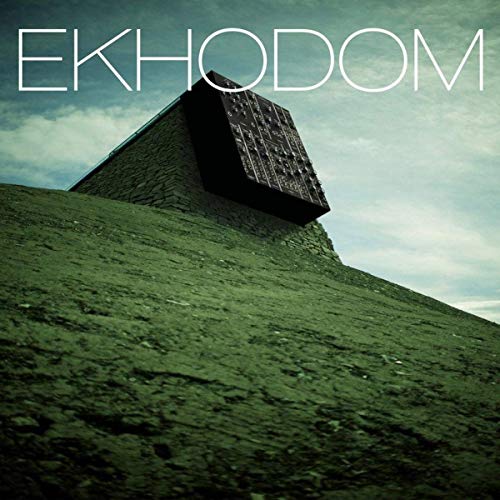 "Album cover with a pyramid-shaped building on a grassy hill under a cloudy sky."