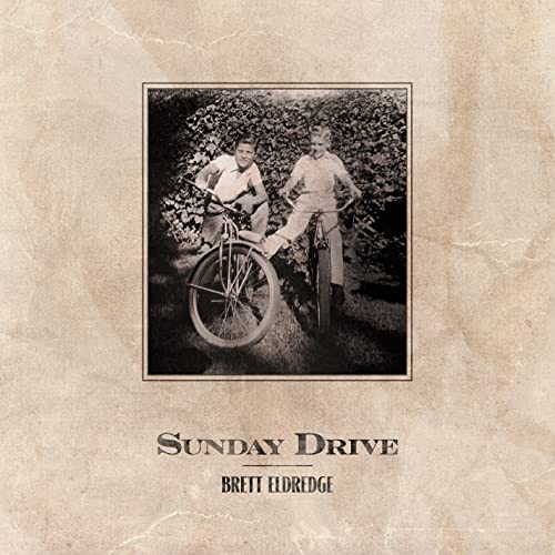 Vintage photo of two people on bicycles, album cover for Brett Eldredge.