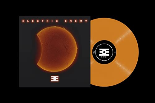 Orange vinyl record with eclipse-themed album cover, black background.