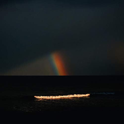 Dark seascape with a rainbow and glowing horizon, album cover art.