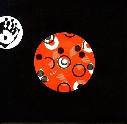Orange vinyl record with abstract circular designs on a black background.