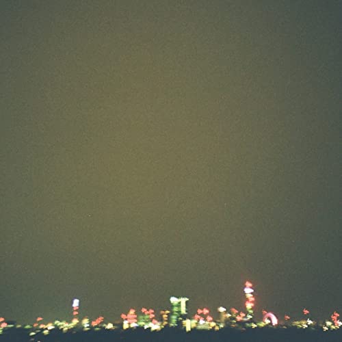 Dark album cover with blurred, colorful city lights along the bottom.