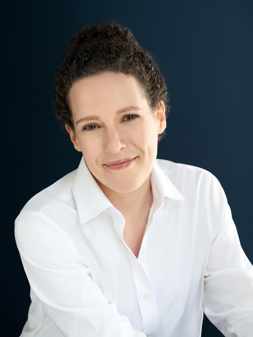 Portrait of a smiling woman with curly hair wearing a white shirt.