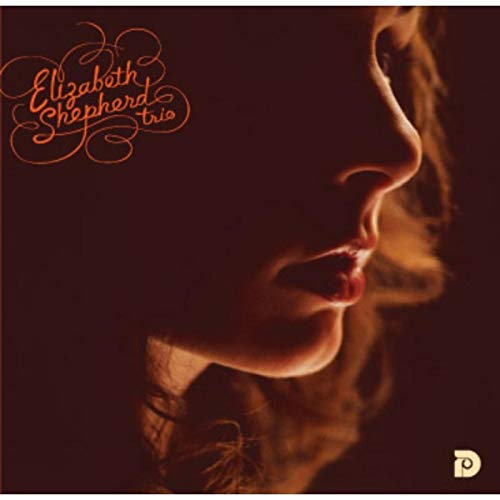 CD cover: close-up portrait of a woman with orange script text.