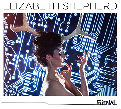 A woman with antlers poses in front of a glowing blue circuit board background.