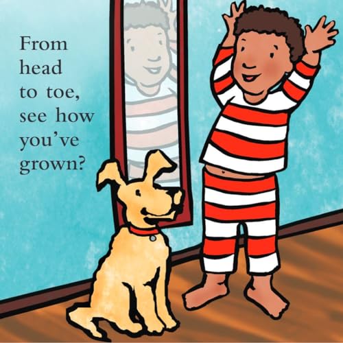 A young boy and dog looking at the boy's reflection in a mirror.