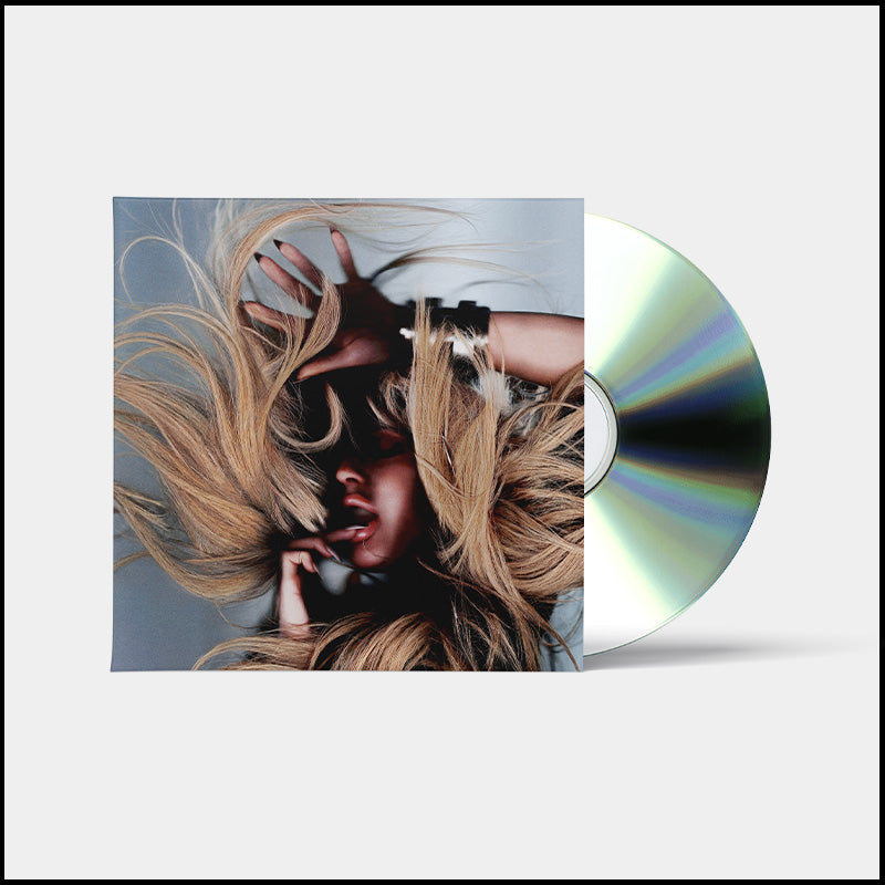 Ellie Goulding CD cover with flowing blonde hair and a silver disc.