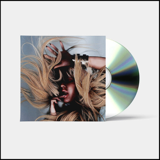 Ellie Goulding CD cover with flowing blonde hair and a silver disc.