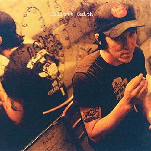 "Album cover featuring a man in a baseball cap, with a reflective, mirrored effect."