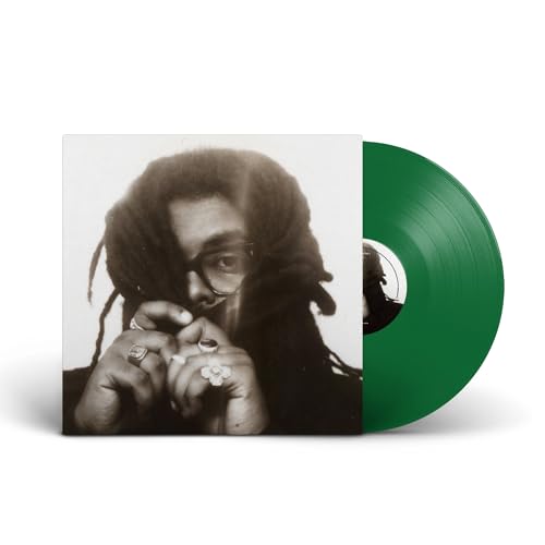 Vinyl record album featuring a black and white portrait and a solid green disc.