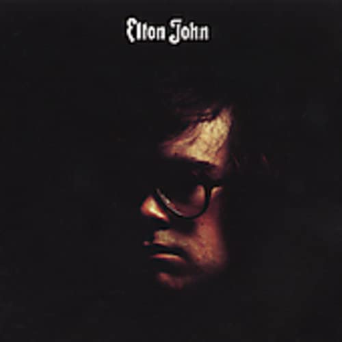 Elton John album cover: a shadowed portrait with text above.
