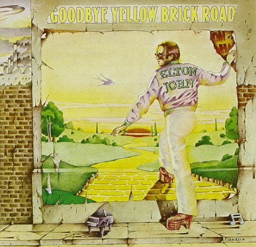 Elton John walking into a painted landscape of a yellow brick road on album cover.