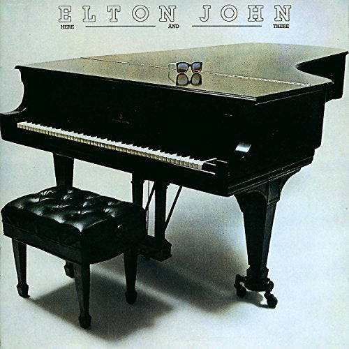 Elton John album cover: black piano with sunglasses on top.