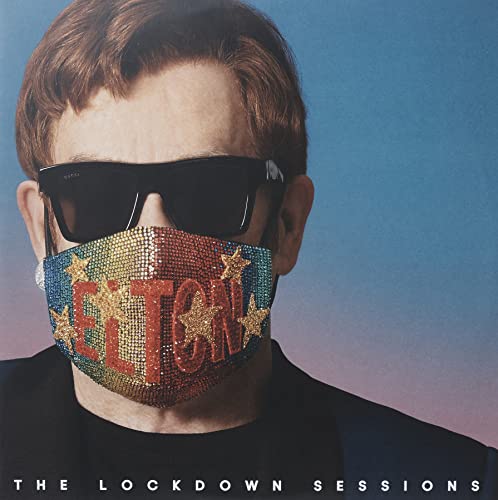 Elton John wearing sunglasses and a bejeweled face mask with his name on the album cover.