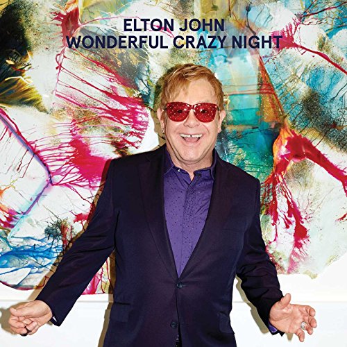 Elton John in suit and red glasses, album cover background.