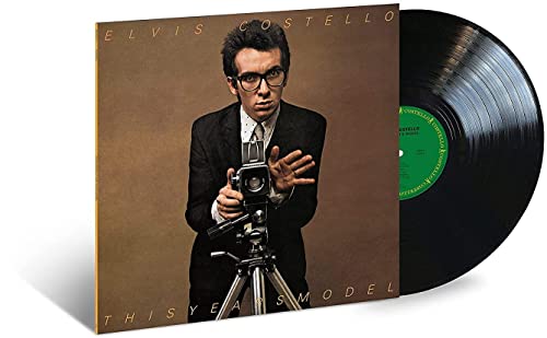 Elvis Costello album cover with a vinyl record beside it.