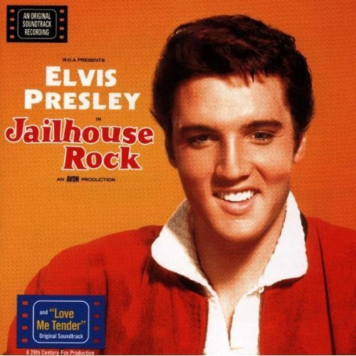 "Elvis Presley album cover with a portrait of Elvis against an orange background."