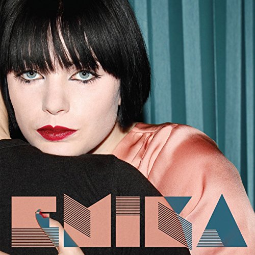Close-up portrait of Emika, a woman with dark hair and red lips.