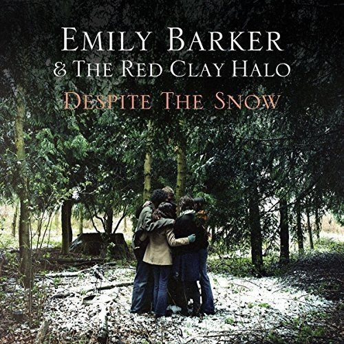 "Album cover with three people hugging in a snowy forest, text at the top."