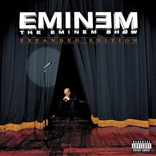 Eminem album cover: man with microphone behind dark curtains.
