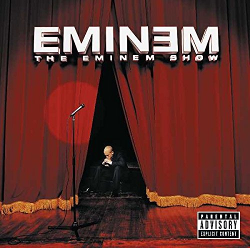 "Eminem album cover featuring the rapper on stage behind red curtains."