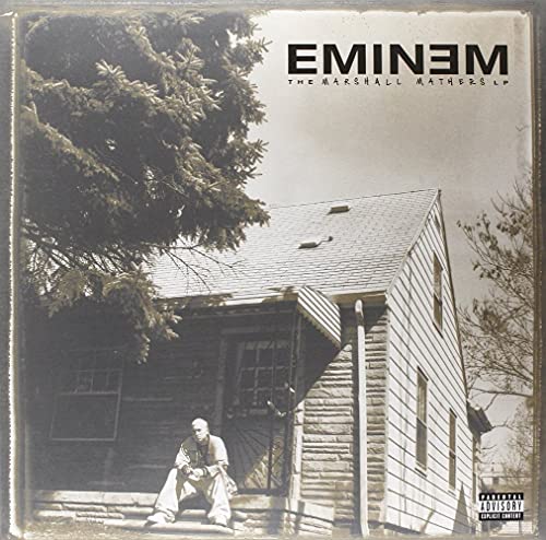 Eminem sitting on the porch of a house on The Marshall Mathers LP cover.