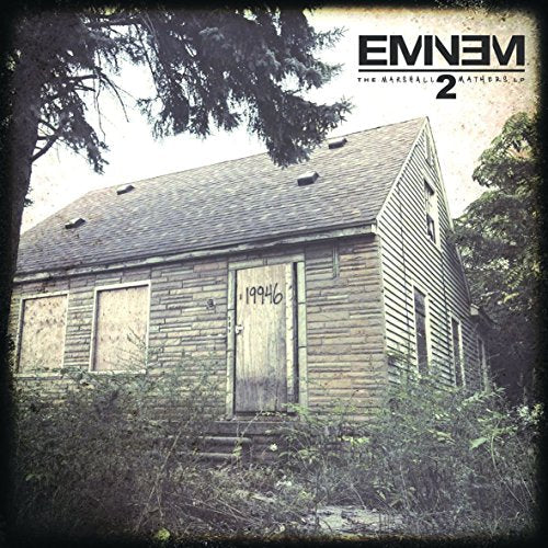 Eminem album cover: dilapidated house with "19946" graffiti, dark tone.