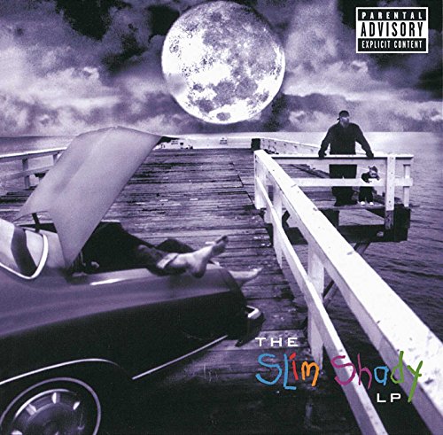 Eminem standing on a pier with a child under a large full moon.