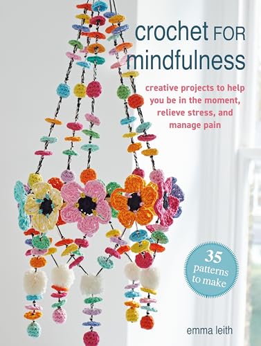 Book cover with colorful crocheted flowers and hanging decorations.