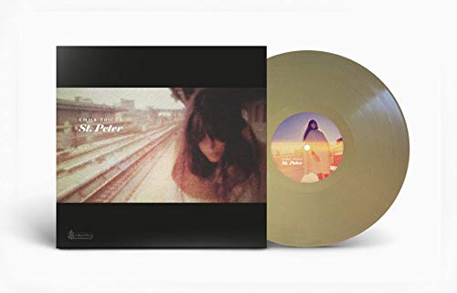 Gold vinyl record with album cover featuring a woman and railway.