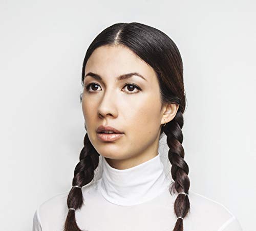 Portrait of Emmy The Great, a woman with braided dark hair.
