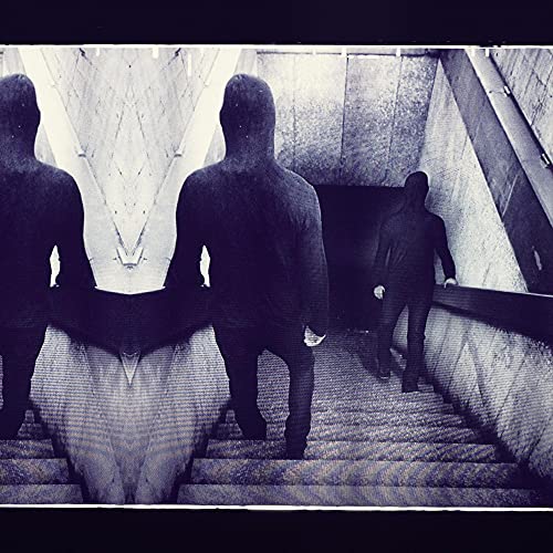 GrainCSymmetrical, grainy image of hooded figures in dark clothing on concrete stairs.